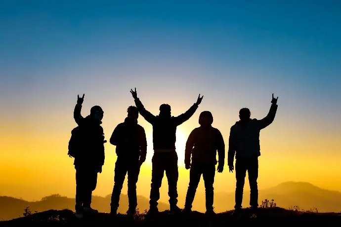 silhouette of people raising their hands
